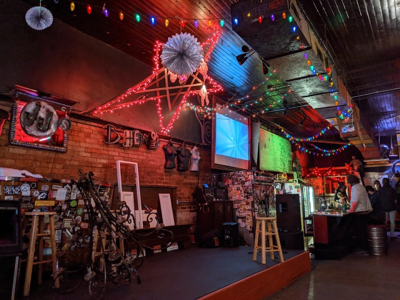 view of jj's bohemia stage/bar area with red lighting