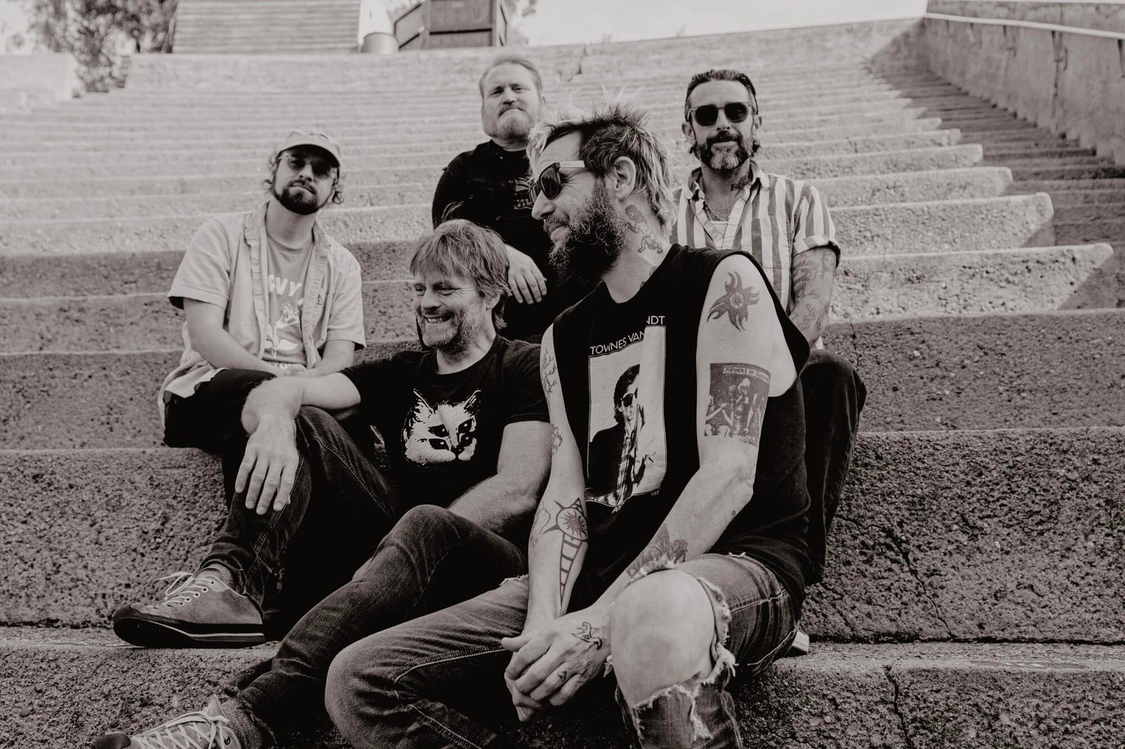 band of horses promo photo of five band members sitting on steps