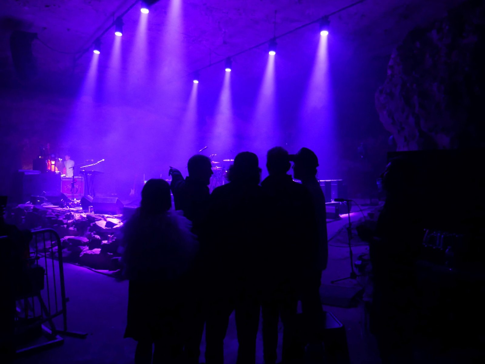 slowdive band standing in group beside stage at the caverns